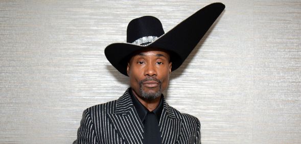 Billy Porter at the 2019 Emmy Awards in a black and silver suit and huge black hat.