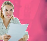 This is an image of a white woman with shoulder length blond hair holding a piece of paper. The background is a blurred out meeting room and is stylised in fuschia.