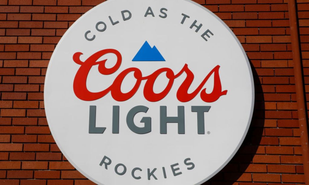 This is an image of the Coors Light Logo. There is a mountain in blue, and in cursive red lettering reads Coors and silver block lettering LIGHT.