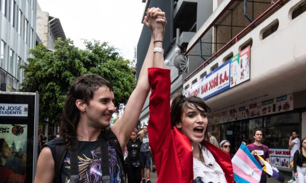 People hold hands during a march to celebrate the international day of non-binary people in San Jose, on July 16, 202e