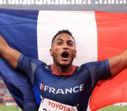 French Paralympic athlete Dimitri Pavadé holds French flag behind him