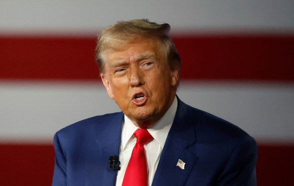 Republican presidential nominee, former U.S. President Donald Trump participates in a Town Hall debate. He's wearing a navy suit with a white shirt.