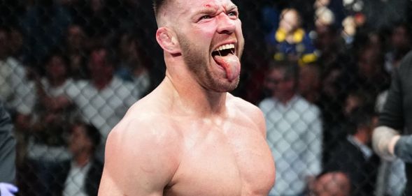 Dricus du Plessis with his tongue out in a UFC cage.