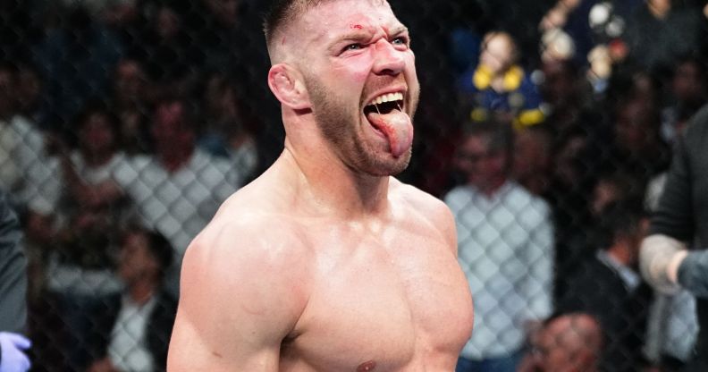 Dricus du Plessis with his tongue out in a UFC cage.