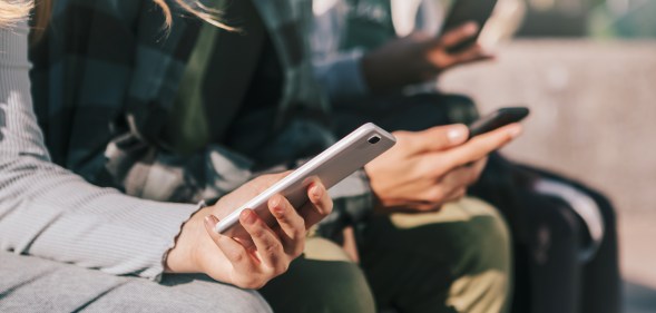 Young people using their mobile phones.