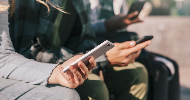 Young people using their mobile phones.