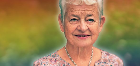 A photoshopped picture of Jacqueline Wilson infront of a rainbow background.