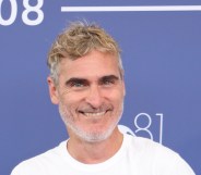 Joaquin Phoenix smiling during the press shoot at Venice Film Festival