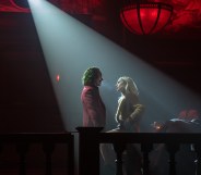 Joker and Harley Quinn in a spotlight