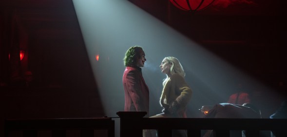 Joker and Harley Quinn in a spotlight