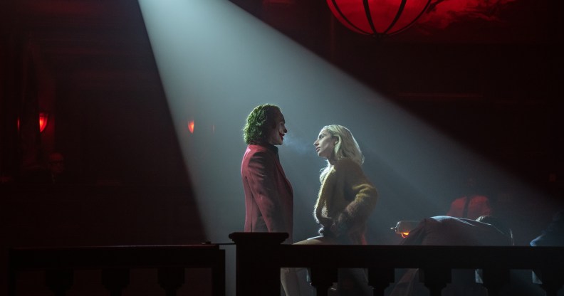 Joker and Harley Quinn in a spotlight