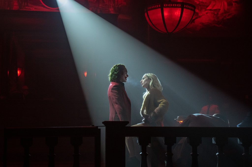 Joker and Harley Quinn in a spotlight