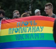 A participant holds a banner with the inscription 'Stop propaganda of violence' during the Gay Pride demonstration in St. Petersburg, Russia