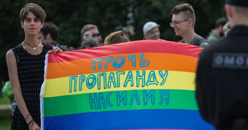 A participant holds a banner with the inscription 'Stop propaganda of violence' during the Gay Pride demonstration in St. Petersburg, Russia