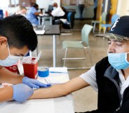 registered nurse with The Los Angeles Department of Public Health administers a Mpox vaccine