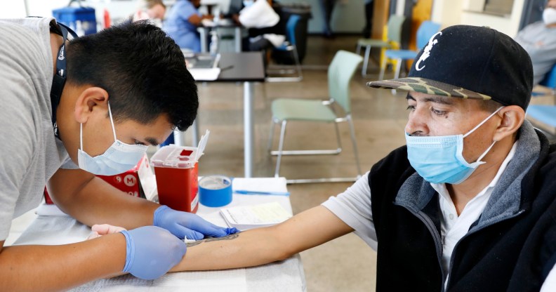 registered nurse with The Los Angeles Department of Public Health administers a Mpox vaccine