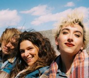 National Anthem still: Charlie Plummer, Eve Lindley, and Mason Alexander Park in the back of a truck wearing denim jackets, their hair blowing in the wind.