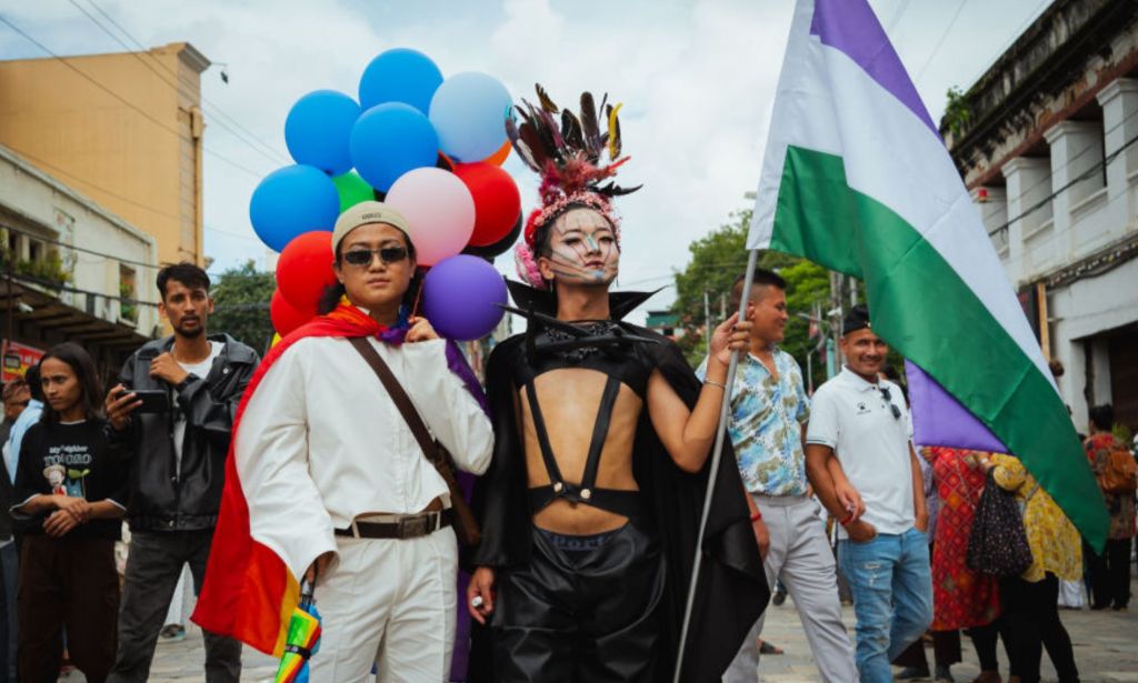 Two members of the LGBTIQ+ community pose for a portrait, one holding the Genderqueer Pride flag on August 20, 2024 in Kathmandu, Nepal. Gai Jatra is a Nepalese festival celebrated mainly in the Kathmandu valley by the Newar people to honour immediate relatives who have died during the previous year. Over the course of several days, Durbar Squares around Kathmandu are filled with revellers, dancers, and musicians. Families create plinths which are carried along the streets adorned with decorations and photographs of those they have lost. As part of the festival, members of the LGBTIQ+ community also participate in a Pride-style parade to celebrate acceptance and promote anti-discrimination, particularly for the Hijra community, or 'third gender' trans, intersex or eunuch community