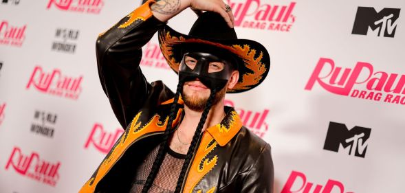 Orville Peck holds his cowboy hat.