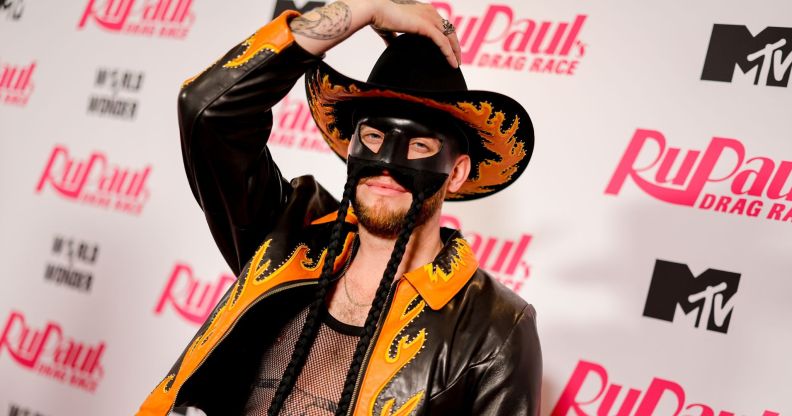 Orville Peck holds his cowboy hat.