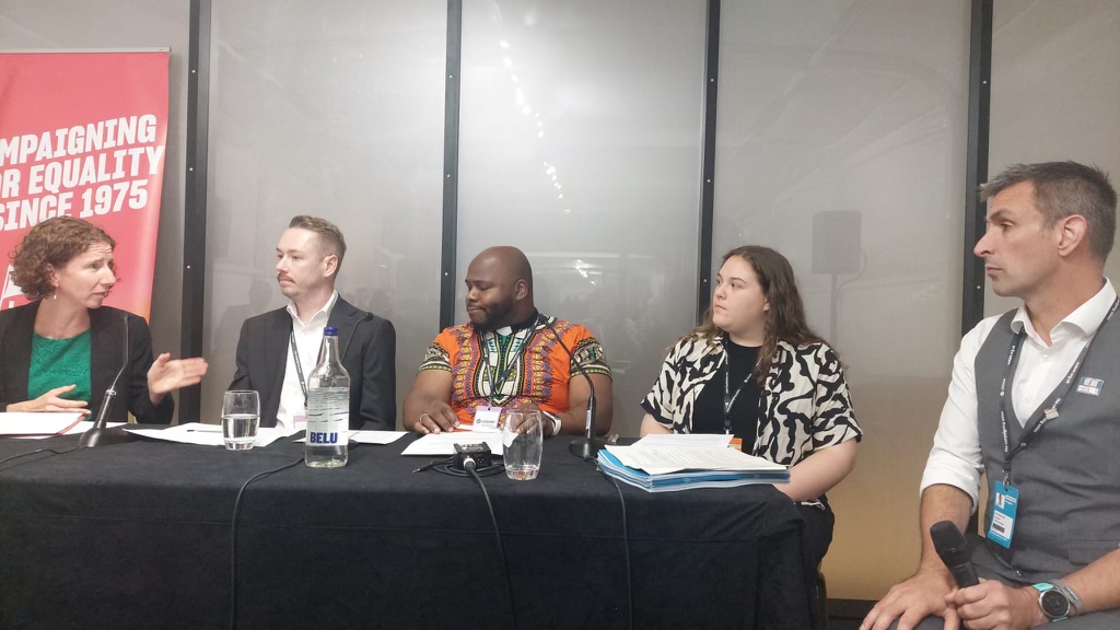 This is a panel discussion with Simon Blake, ceo of Stonewall on the far right side and Women and Equalities Minister for the UK, Anneliese Dodds.