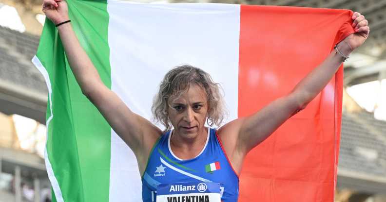 Trans Paralympian Valentina Petrillo holding an Italian flag