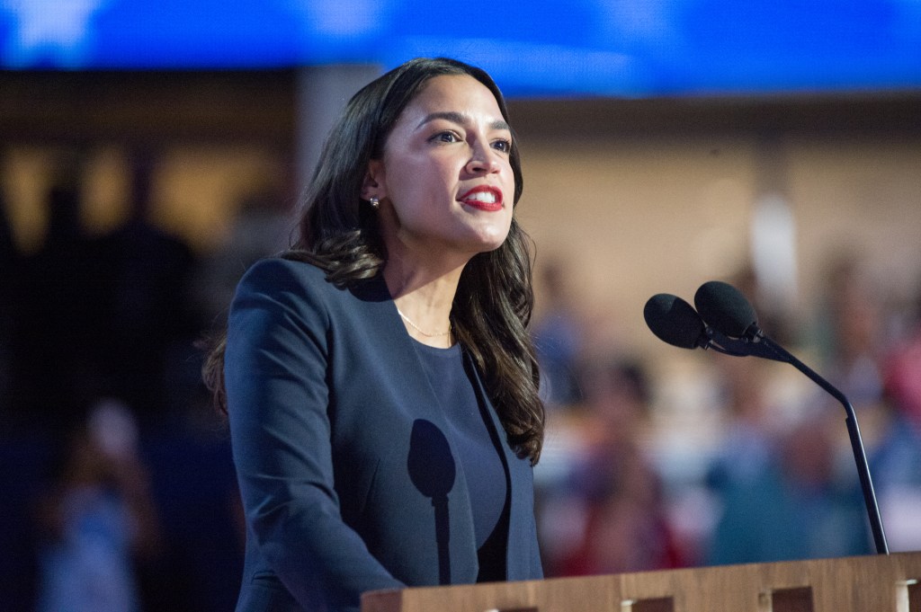 Representative Alexandria Ocasio-Cortez, a Democrat from New York speaking at a podium