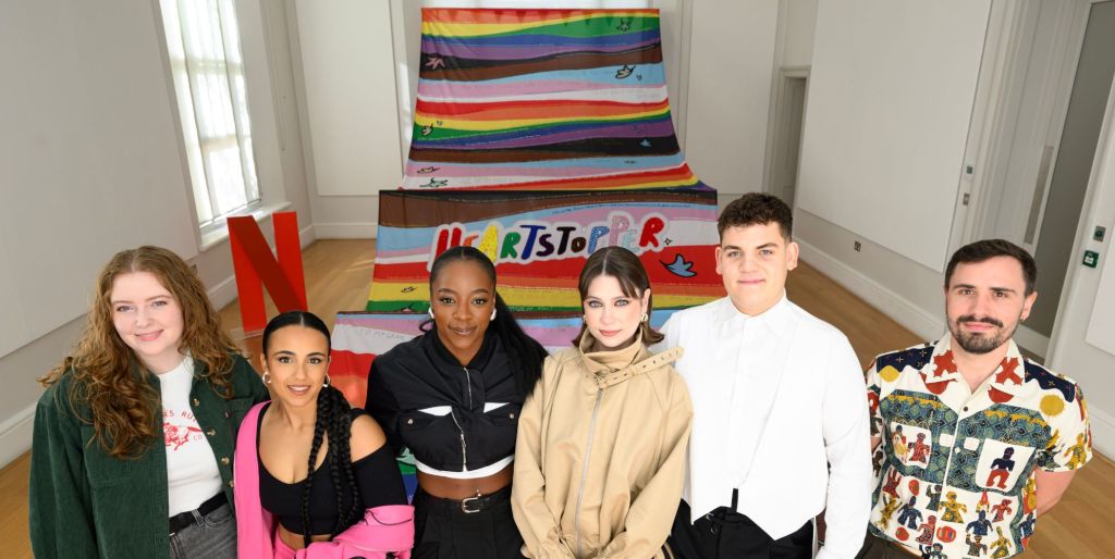 Heartstopper's Alice Oseman, Leila Khan, Corinna Brown, Jenny Walser, Tobie Donovan, and flag creator Raff Dilhan at the launch of Queer Britain's Heartstopper Pride flag.