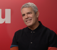 Real Housewives host Andy Cohen in front of a Hayu logo