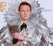 Joe Lycett holding a BAFTA award