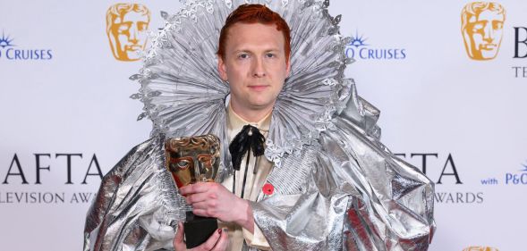 Joe Lycett holding a BAFTA award