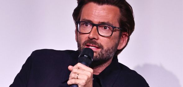 David Tennant, pictured with a microphone in his hand.