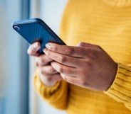 Shot of an unrecognizable woman using a mobile phone indoors