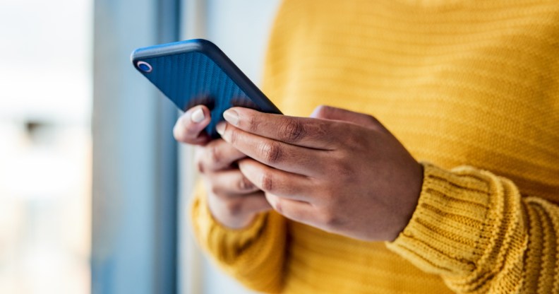 Shot of an unrecognizable woman using a cell phone indoors