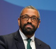 Conservative leadership contender and Shadow Home Secretary James Cleverly wearing a black suit with a green tie