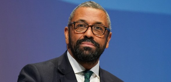 Conservative leadership contender and Shadow Home Secretary James Cleverly wearing a black suit with a green tie