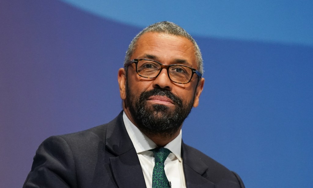 Conservative leadership contender and Shadow Home Secretary James Cleverly wearing a black suit with a green tie