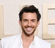 Jonathan Bailey on a white suit smiling