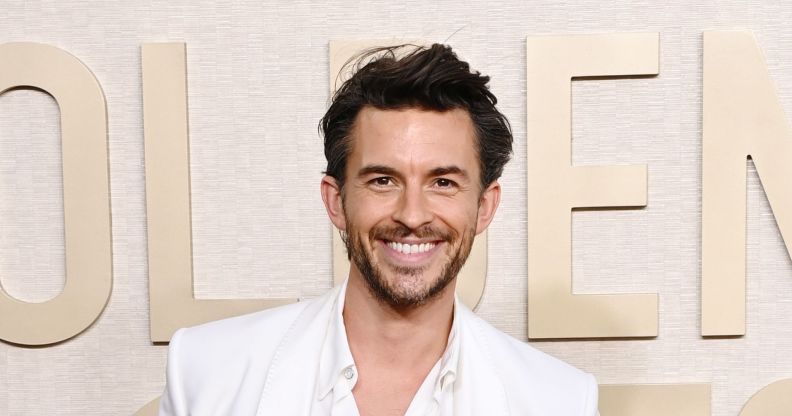 Jonathan Bailey on a white suit smiling