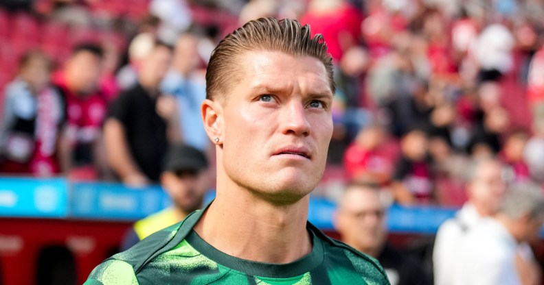 Kevin Behrens of VfL Wolfsburg walks outside to warm up at a football match