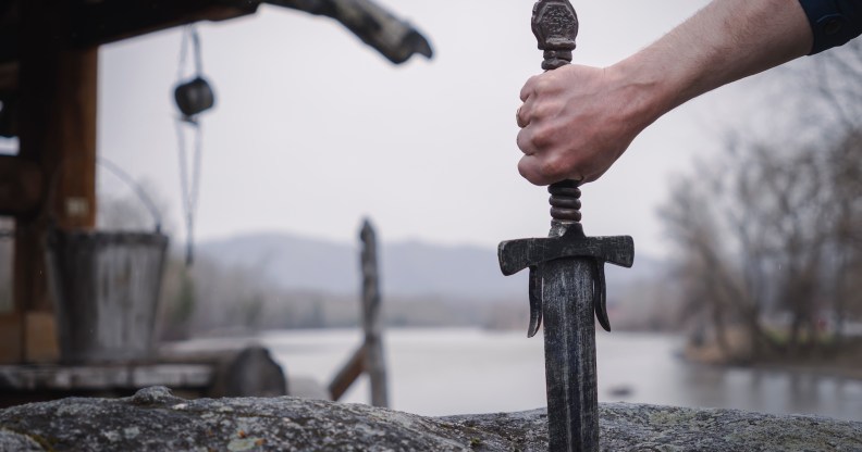 famous sword excalibur of King Arthur stuck in the rock. Edged weapons from the legend Pro king Arthur.