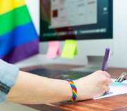 Woman's hand working in office with LGBT decor and accessories. Cultura LGBTQIA