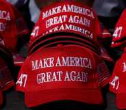 "Make America Great Again" hats sit on a table during a campaign rally for former US President and Republican presidential candidate Donald Trump.