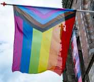 A Progress Pride flag flies as people take part in the Zwolle Pride Parade.