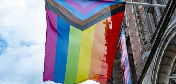 A Progress Pride flag flies as people take part in the Zwolle Pride Parade.