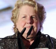 Sandi Toksvig speaking on a podium.