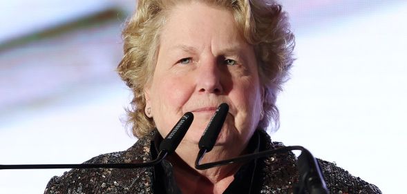 Sandi Toksvig speaking on a podium.