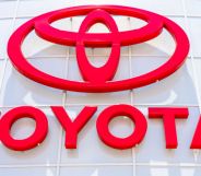 This is an image of a Toyota dealership sign. The lettering and logo is in red.