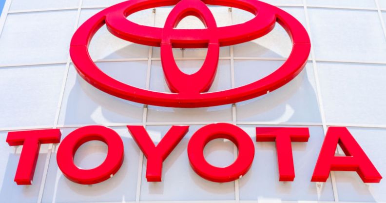 This is an image of a Toyota dealership sign. The lettering and logo is in red.