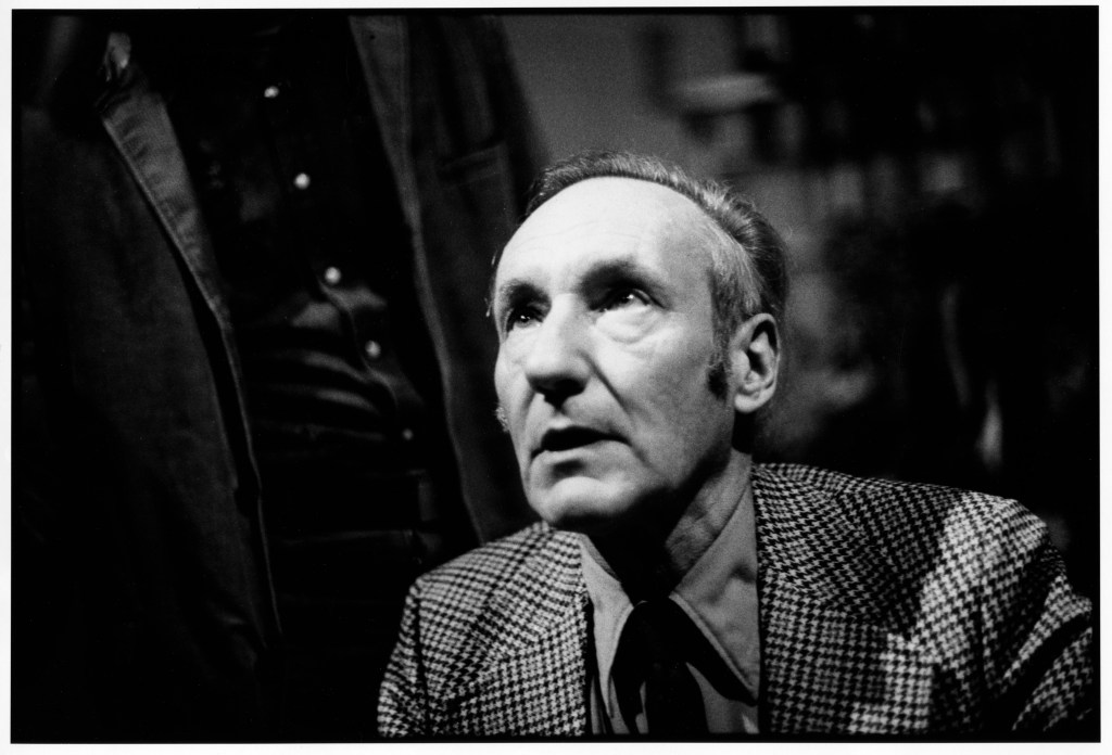 View of American author William S Burroughs looking up, shot from above